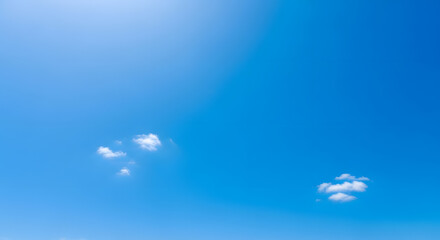 Clear Blue Sky with Two Small Puffy Clouds