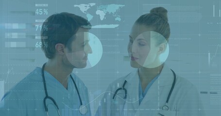 Analyzing data doctors in blue scrubs with stethoscopes at hospital, with digital displays