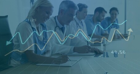 Taking notes medical team sitting at hospital conference table, with laptop and data graphs overlay