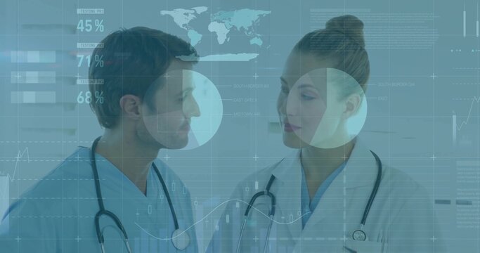 Analyzing data doctors in blue scrubs with stethoscopes at hospital, with digital displays