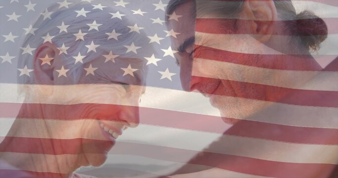 Sharing mature couple touching foreheads and smiling at shoreline, with American flag overlay