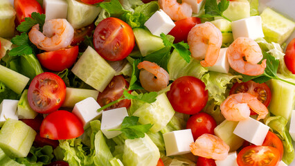 Vegetable salad with shrimp close-up. Healthy food fresh vegetables feta cheese shrimp. High quality photo