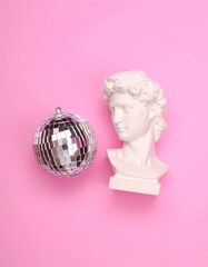 Disco ball and bust on pink background