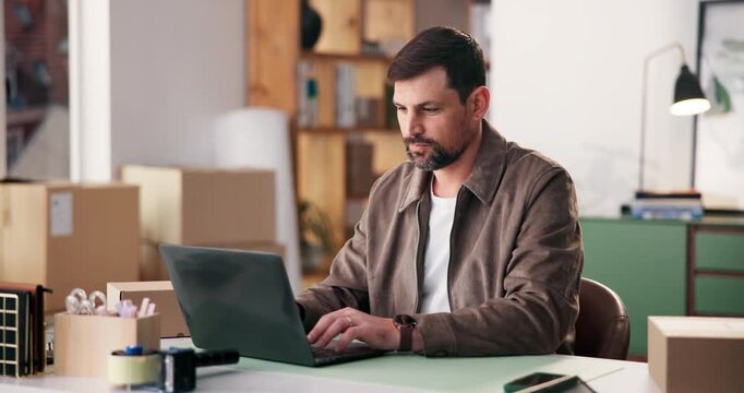 Laptop, supply chain and typing with man in office for delivery, distribution or shipping management. Computer, logistics and schedule with person at desk for courier service, inventory or planning