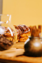 Delicious baked goods displayed on a wooden table in a cozy setting with warm colors