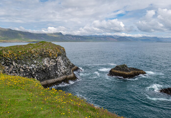 Fototapeta premium Arnarstapi basalt rocks in atlantic ocean in Iceland