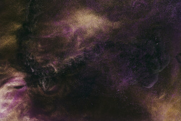 Abstract fluid art background. Moving flow of purple gold paints, dark space sky