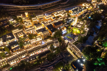 Obraz premium Aerial View of Illuminated Traditional Buildings at Night
