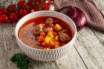 Tomato soup with meatballs and vegetables