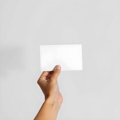 hand holding a blank white paper