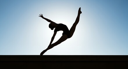 Silhouette of a gymnast performing a split leap against a bright sky