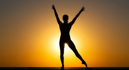 Silhouette of person with arms raised against sunset sky background