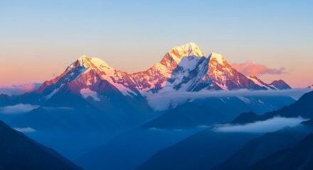 Fototapeta premium Snow-capped mountain peaks illuminated by the warm, soft light of sunrise or sunset. Majestic scenery and high altitude travel. Landscape view of remote mountains in golden hour light
