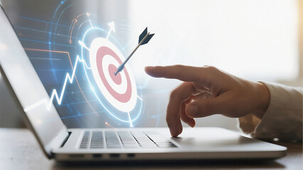 A hand reaching for a target on a laptop screen with an arrow in the bullseye and a graph overlay