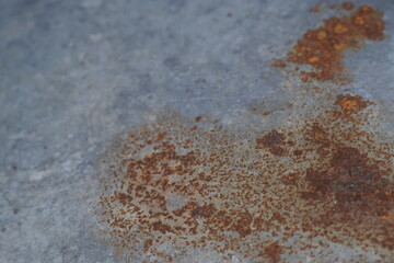 A close - up of a metal surface with patches of rust, showing a corroded and textured appearance