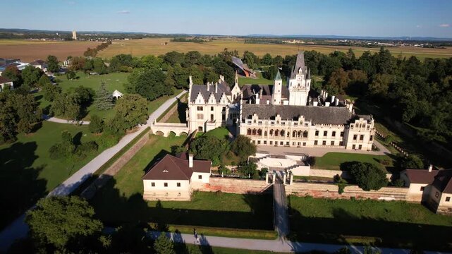 4K cinematic drone footage of Grafenegg Castle in Lower Austria. Majestic Tudor-style romantic castle with historic gardens and towers. Luxury heritage destination near Vienna