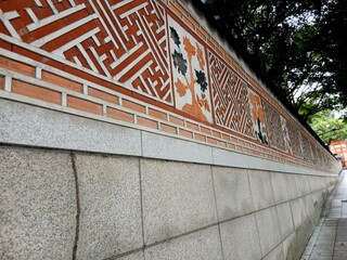 Old stone wall decorated with traditional Korean patterns