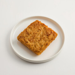fried tempeh wrapped in flour is a typical Indonesian food served on a plate on a white background 