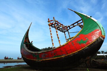 The crescent shaped Boats in Cox's Bazar is called moon boat. Moon boat, a traditional Bangladeshi fishing vessel, Teknaf beach, Cox's Bazar.