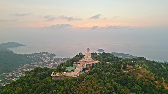 big buddha statue over phuket at pastel sunset