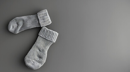 Two socks on neutral grey background. Fashion clothing flat lay