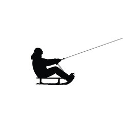 Silhouette of a person on a sled holding a rope against a stark white isolated background scene