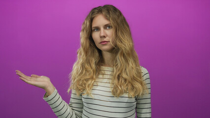 Woman hand presenting studio blonde young index finger purple background creates playful yet...