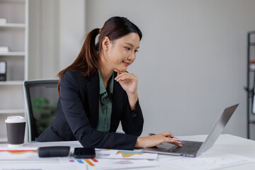 Business asian woman Reviewing Documents, business woman's hands meticulously reviewing a stack of...