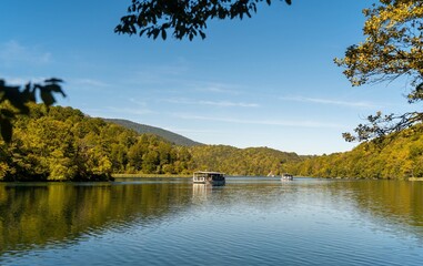 The electric boat for tourists on the Lake Kozjak, one of the Plitvice Lakes, on a sunny, autumn day. 