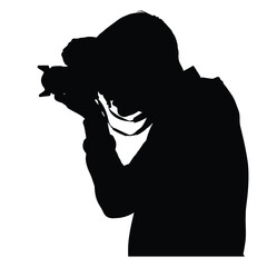 Silhouette of a photographer holding a camera up to their eye taking a photograph image art
