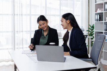 Team work asian women process. Marketing strategy brainstorming. Paperwork and digital in open space. Ideal for showcasing teamwork and strategic planning.
