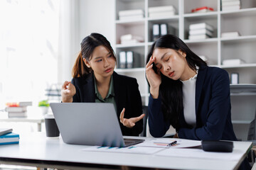 Fototapeta premium Stressed overwhelmed business colleagues feeling tired at corporate meeting. Business people conflict problem. Stress at work or migraine concept. Solving problem in an office. 