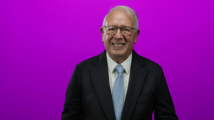 Senior man in business suit appearing desperate against isolated pink background, expressing...