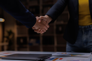 B2B, handshake and partnership with business women in office at night for thank you or welcome. Bokeh, deal and mockup with employee people shaking hands for team onboarding or recruitment on space
