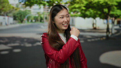 Woman smiling in urban street wearing red jacket enjoying sunny day in city setting vibrant atmosphere outdoors