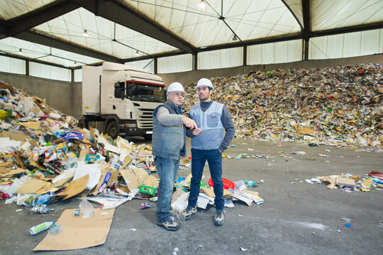 worker pointing at recycling pile