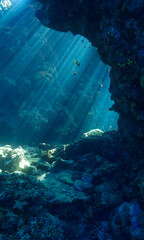 Cathedrals of light - Underwater photo of rays of sunlight inside caves. and tunnels From scuba cave diving in the south of Egypt. St:Johns reef.