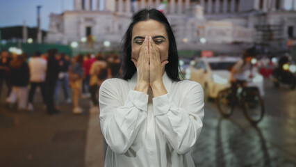 Fototapeta premium Woman smiling in a busy street with city lights and blurred people, expressing surprise and joy, capturing the essence of an urban outdoor scene.