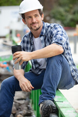 Fototapeta premium young handsome builder during coffee break