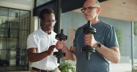 Man, physiotherapist and dumbbells with talk, strength training and motivation for healing process. Person, senior patient and guide for weightlifting exercise, rehabilitation and advice at clinic - Powered by Adobe