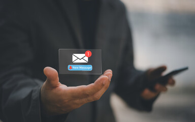Businessman touching new message notification icon on virtual screen,email alert, online messaging system, representing digital communication, instant response, and business connectivity.