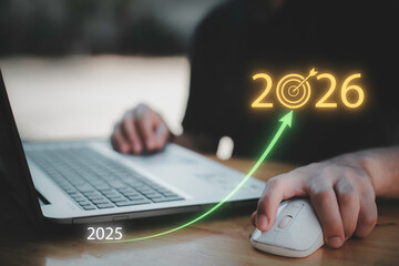 Businessman touching 2026 with arrow target icon, representing new year business goal, strategic planning, vision, annual growth and roadmap for success from 2025 to the future.