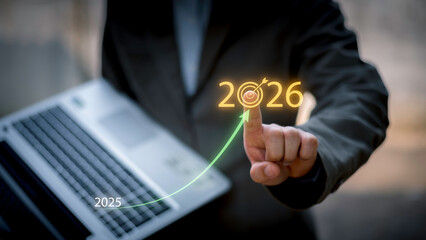 Businessman touching 2026 with arrow target icon, representing new year business goal, strategic planning, vision, annual growth and roadmap for success from 2025 to the future.