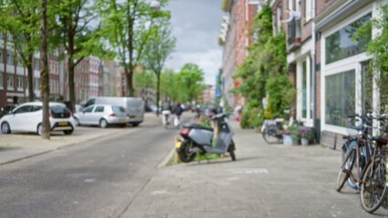 Blurred city street captures defocused view of european town with motorbikes, bicycles, and cars...