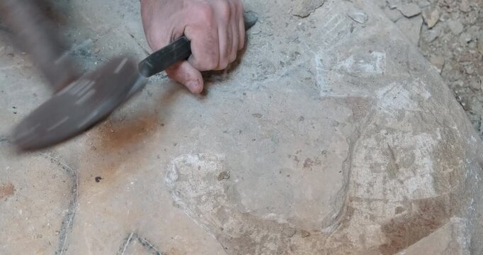 Close-up of a chef pressing flatbread (lavaş) onto a hot griddle (sac). The cook soaks the bread in the spicy meat juices and steam to add flavor. Preparing traditional Turkish street food.
