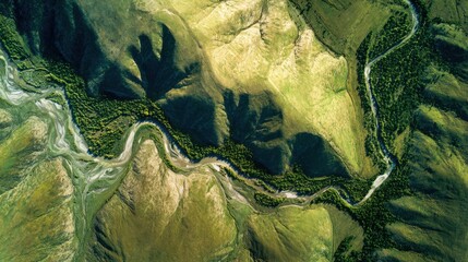Naklejka premium Aerial view of a winding river through a vibrant green landscape.