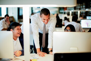 Teacher talk with students on computer desk at library. Learning in library with students and teacher. Technological education and learning. Students enjoy lesson with computer with teacher in library