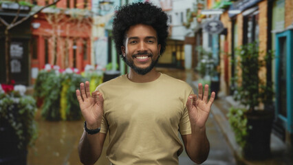 African american man meditates with closed eyes on a vibrant city street, signifying calm and focus...