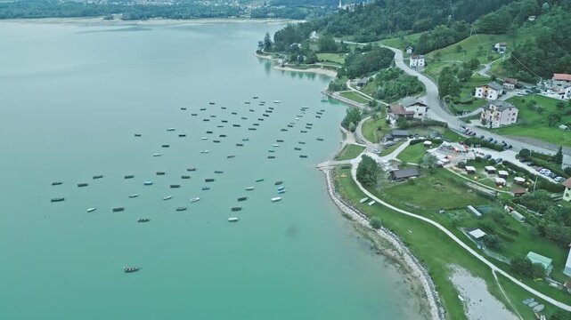 Aerial of moored boats and turquoise water at Lago di Santa Croce, Veneto