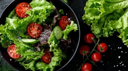 A vibrant salad bowl filled with fresh lettuce, cherry tomatoes, and cucumbers, topped with sea salt. - Powered by Adobe